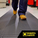 Heronair anti-fatigue PVC matting showing tubular drainage design and etched surface pattern in industrial setting