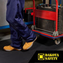 Worker in safety boots using Firmagrip anti-slip matting with wheeled cart, showing industrial workplace application