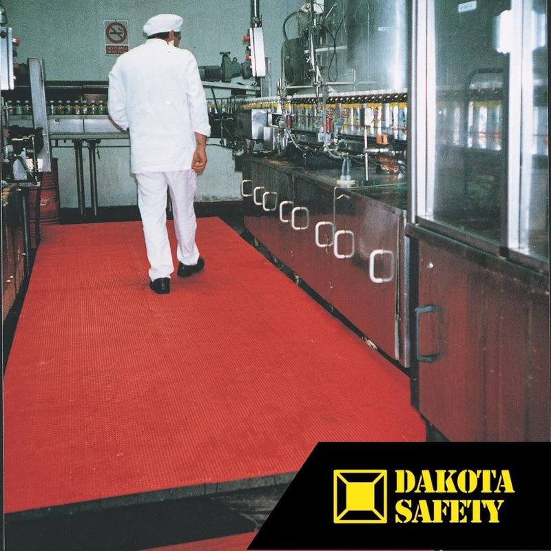 Firmagrip red safety matting in food production facility, showing chemical-resistant surface for wet processing areas