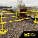 SafetyRail 2000 OSHA-compliant yellow guardrail system installed on rooftop around access hatch, showing non-penetrating base plates