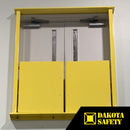 Front view of a yellow self-closing mezzanine gate mounted inside a double hollow-metal door frame.