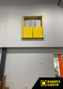 Wide view of a yellow self-closing mezzanine door gate installed in an upper-level warehouse doorway.
