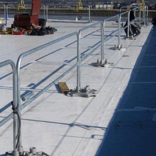 SafetyRail 2000 galvanized guardrail system installed on commercial rooftop, showing continuous run with base plates and mid-rail protection