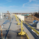 SafetyRail 2000 portable rooftop fall protection system with yellow powder-coated finish and non-penetrating bases on commercial building