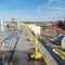 SafetyRail 2000 portable rooftop fall protection system with yellow powder-coated finish and non-penetrating bases on commercial building